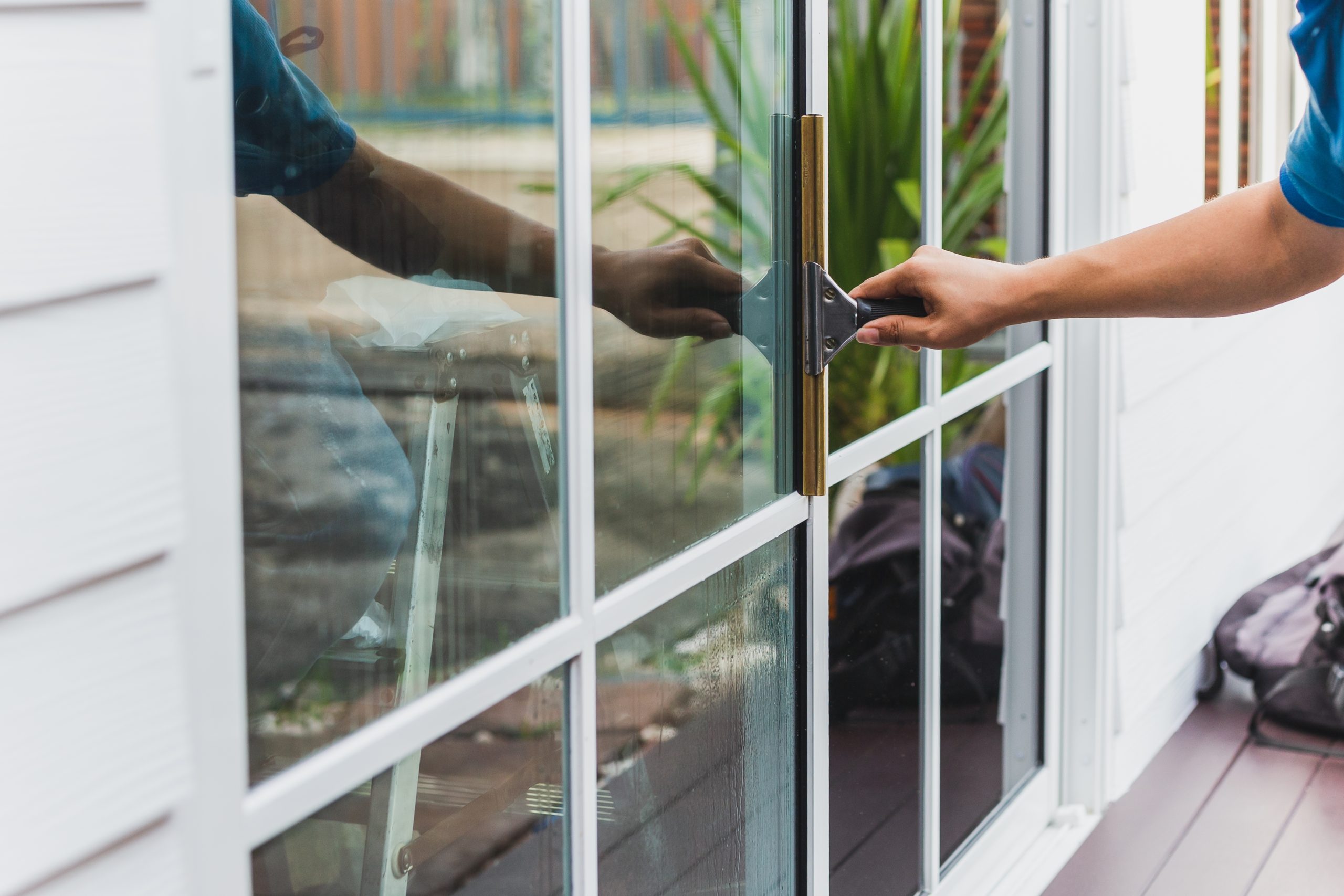 Cleaning windows with a scraper image