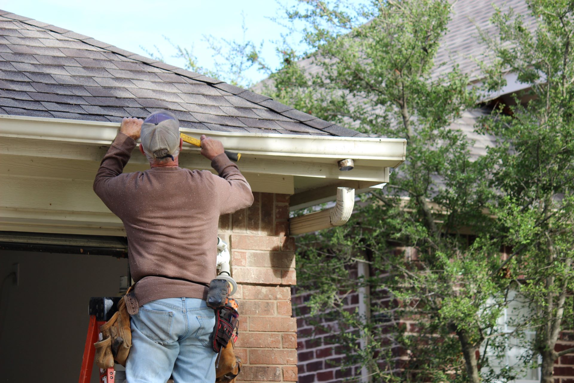 Hammering gutter into place